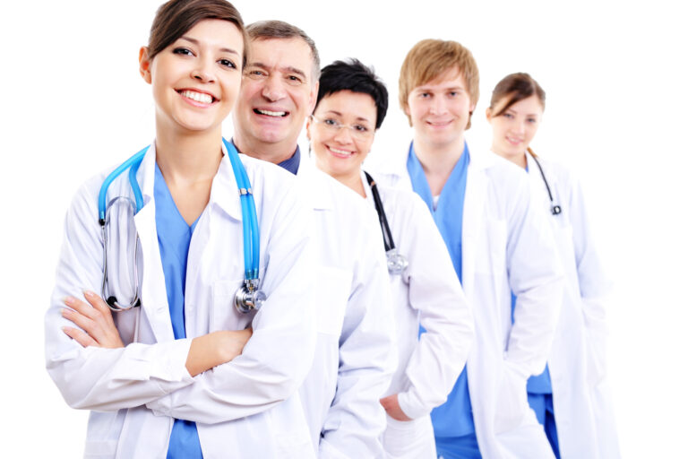 happy laughing female doctors in hospital gowns in row scaled